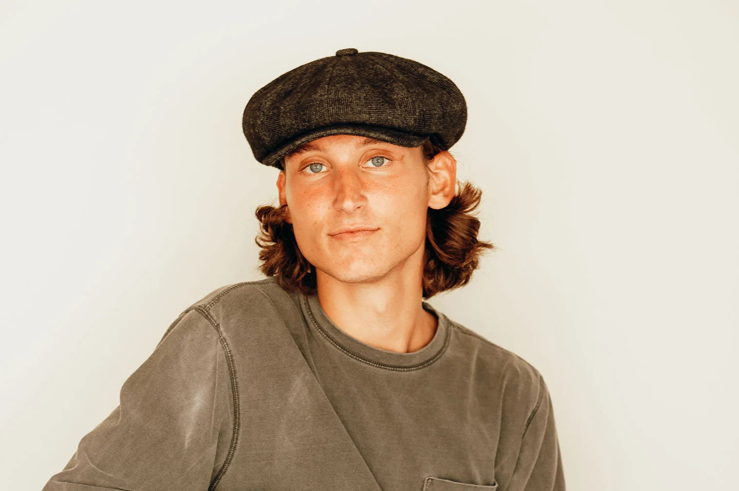 Man posing with the Argo mens cap by American Hat Makers