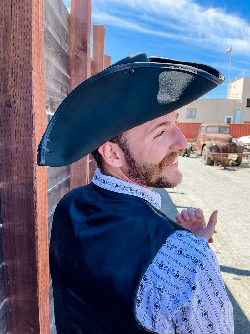 A back side view of a man wearing a black top hat