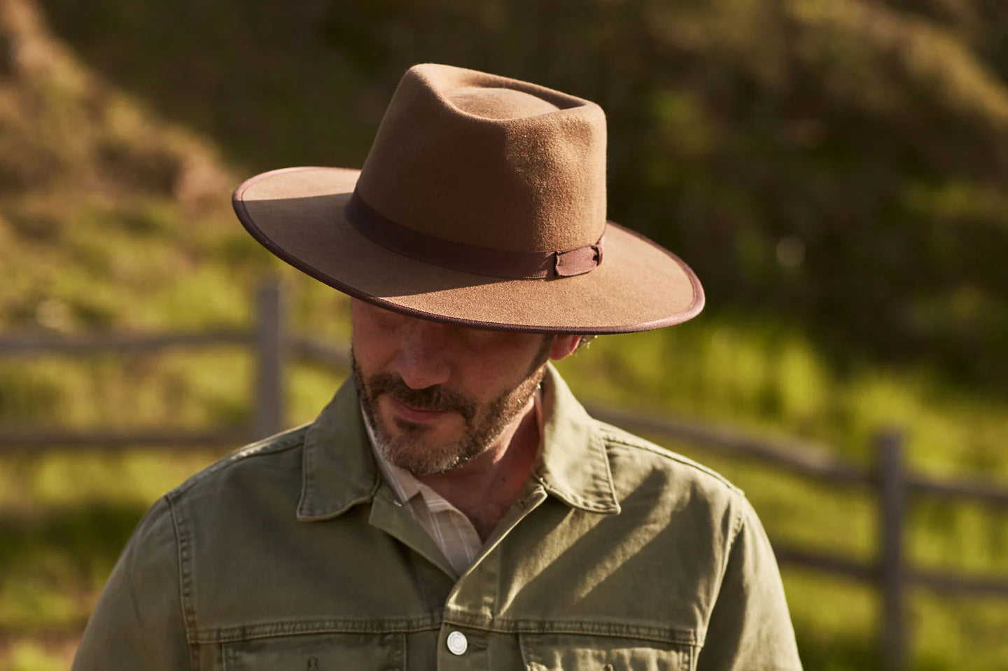 Man standing in field while wearing the Bondi mens wide brim hat by American Hat Makers