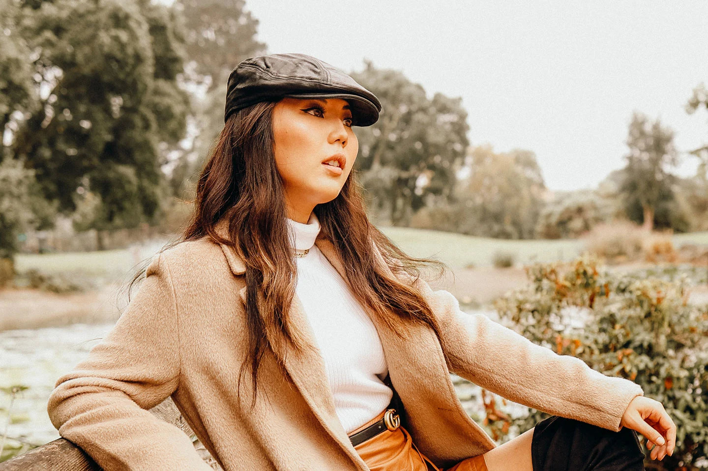 Woman sitting on bench wearing the Bookie womens cap by American Hat Makers