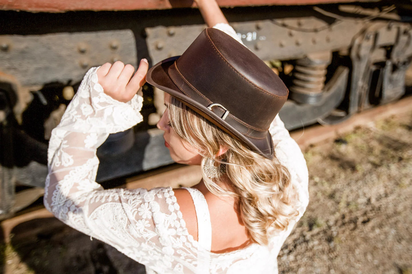 Woman next to train wearing the Bromley womens pork pie hat by American Hat Makers