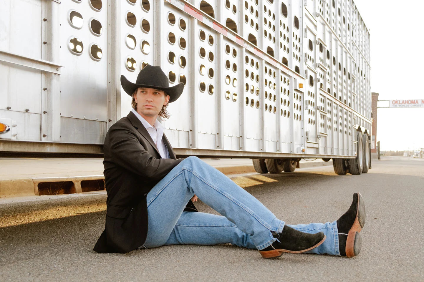 Man leaning against truck while wearing the Cattleman mens cowboy hat by American Hat Makers