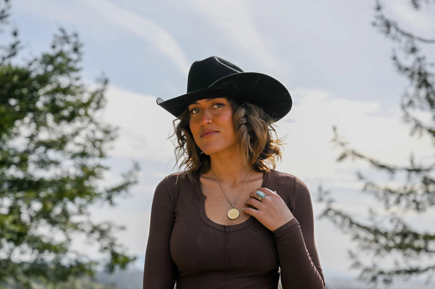Woman posing in the black cattleman cowgirl hat by American Hat Makers