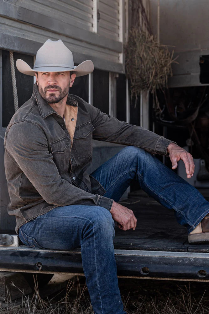 Man sitting in horse trailer wearing the Cattleman mens hat by American Hat Makers