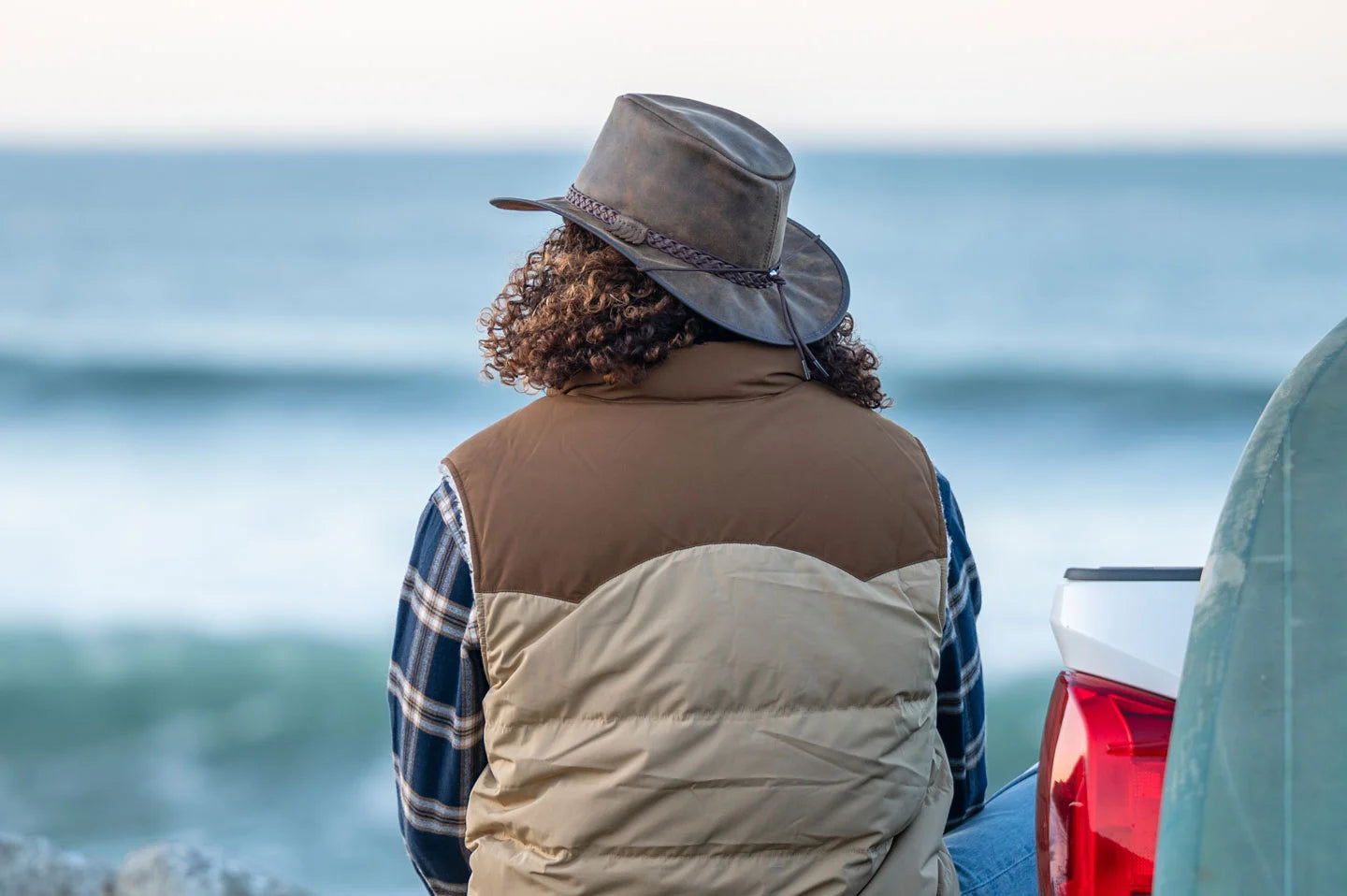 Man sitting at the beach wearing the crusher australian outback hat by American Hat Makers