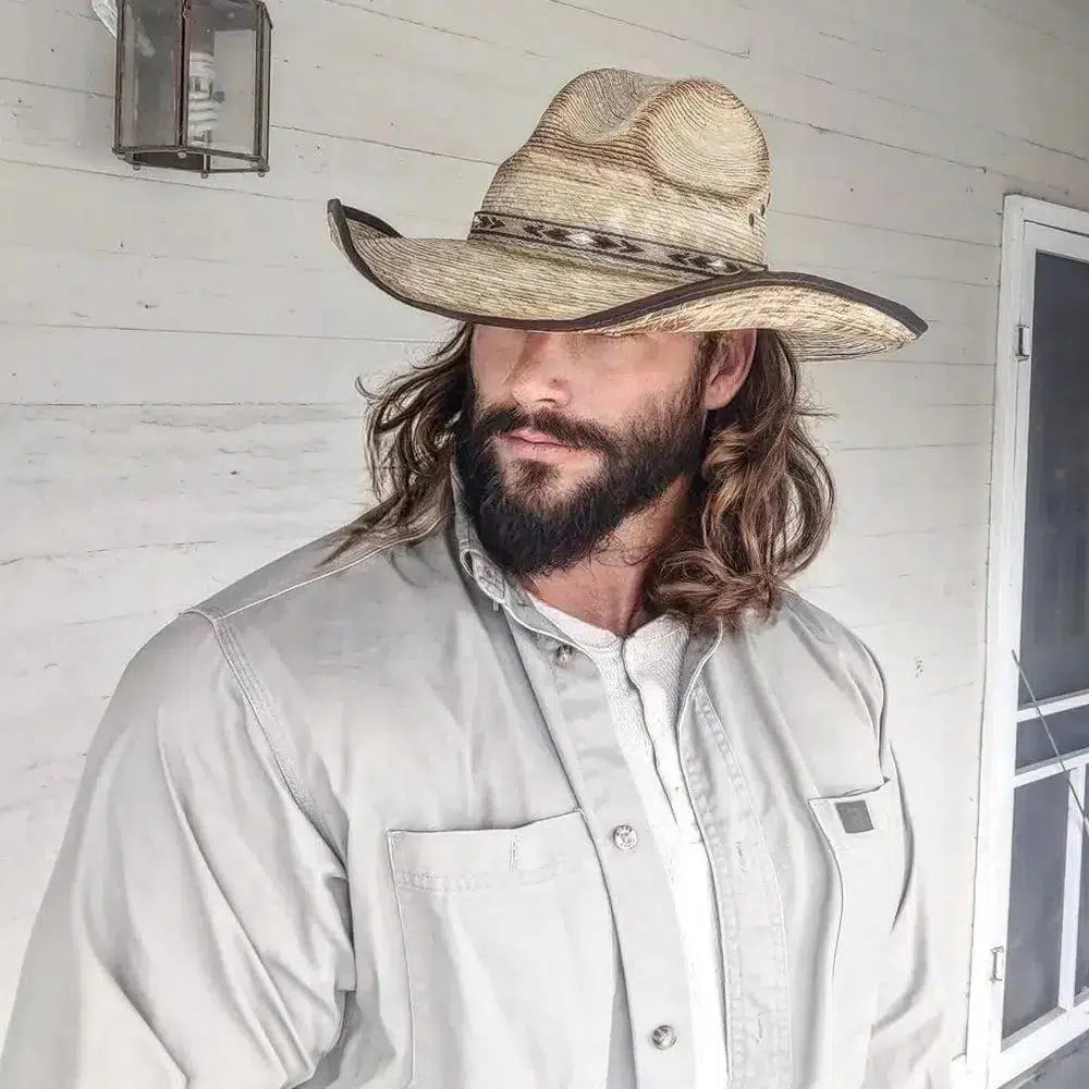 man looking away wearing a palm straw diego hat