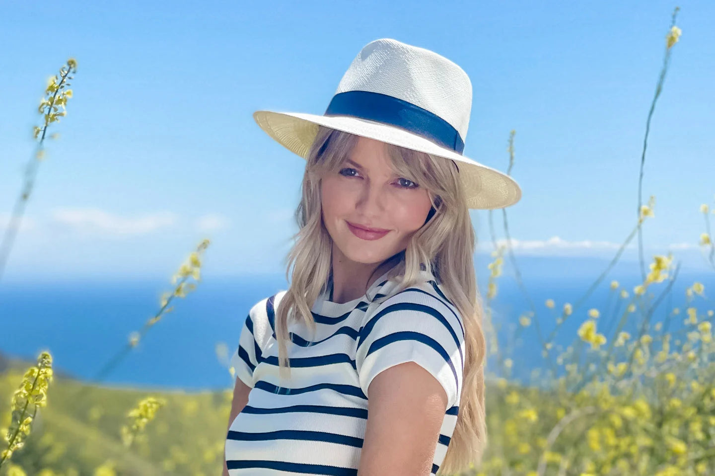 Woman in flower field wearing the Medellin womens panama hat by American Hat Makers