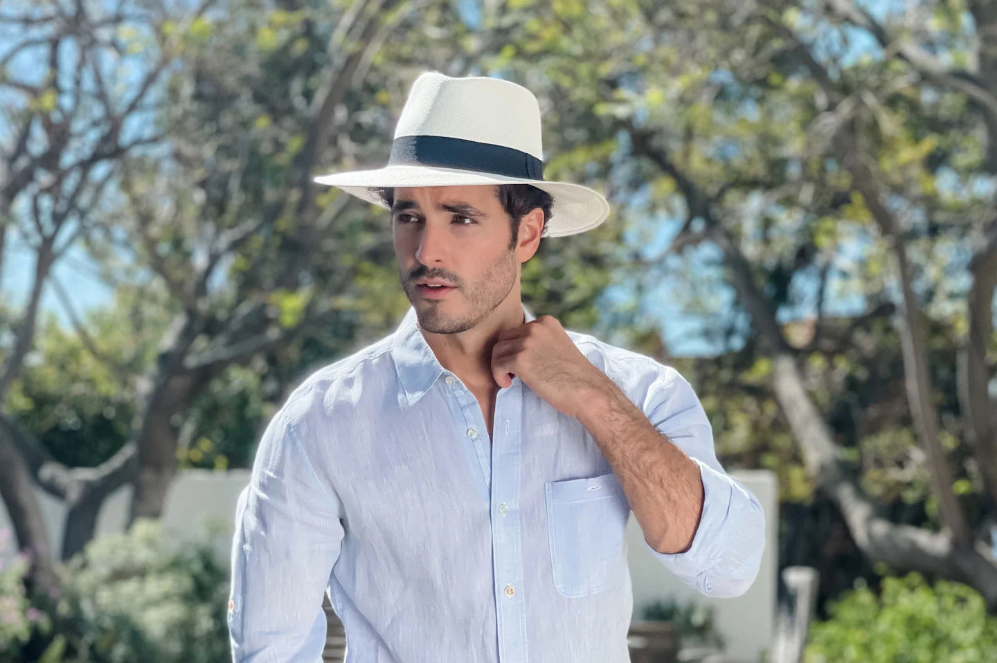 Man posing in trees wearing the Medellin mens panama hat by American Hat Makers