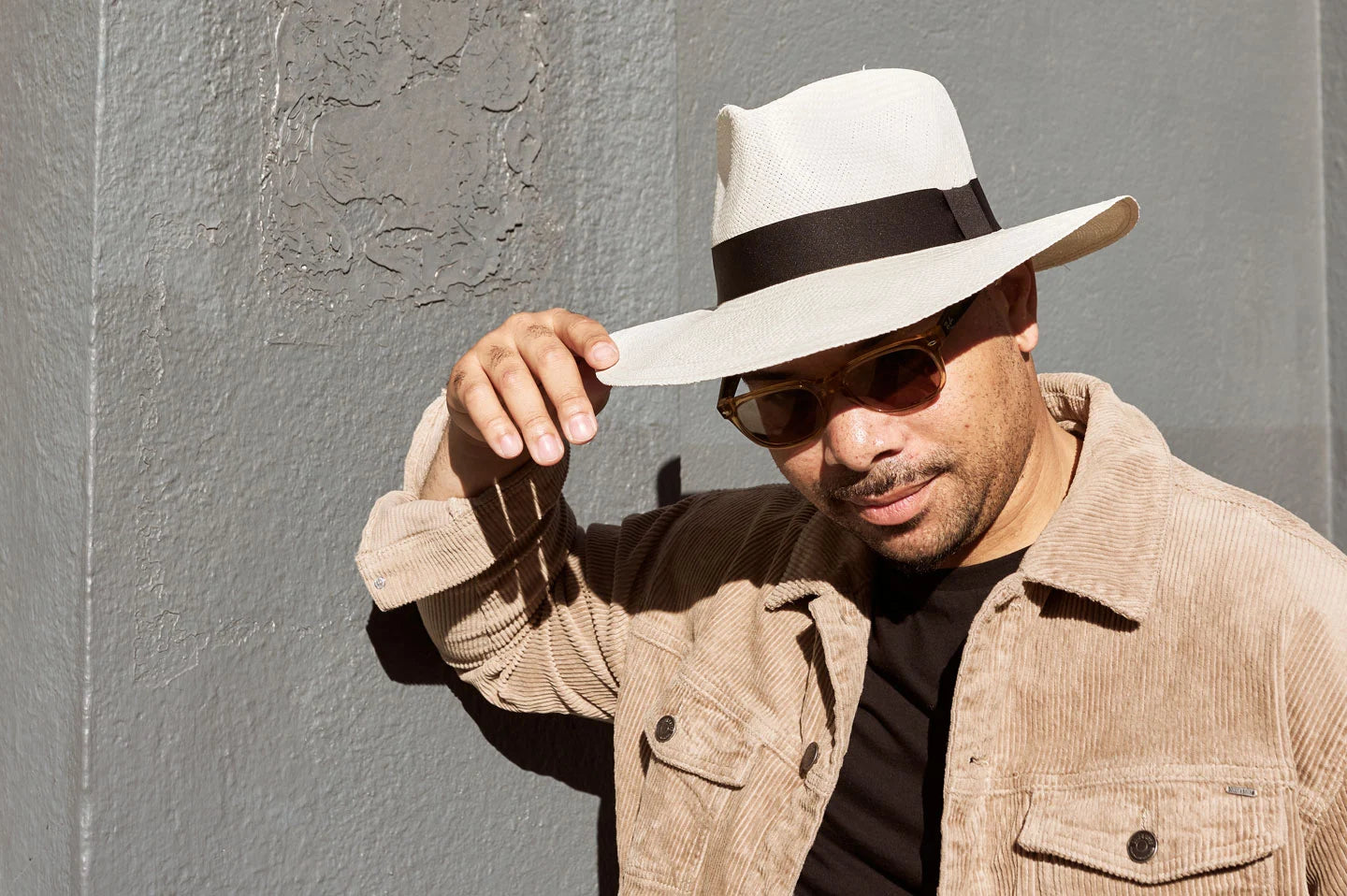 Man next to wall wearing the Medellin mens panama hat by American Hat Makers