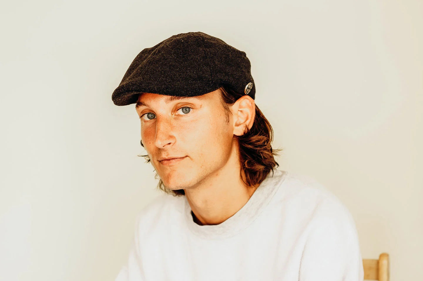 Man posing with the Model C mens cap by American Hat Makers