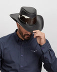 Man tipping his black Pinto leather hat.