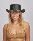A smiling girl wearing an gold sleeveless and a black straw top hat