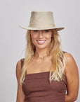 A woman wearing Rogan Hemp Khaki Fabric Sun Hat 