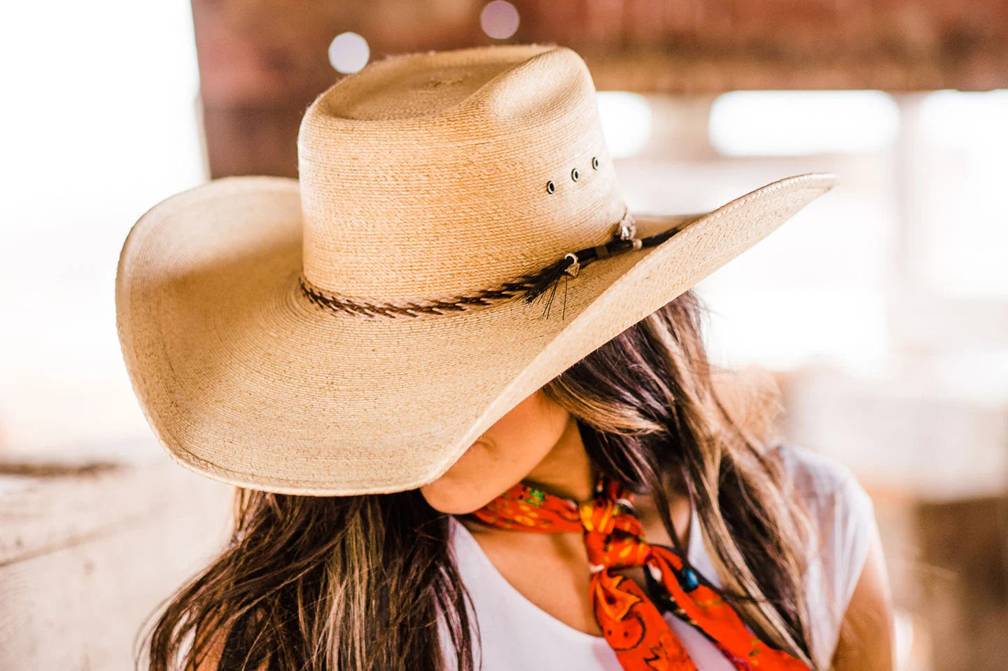 Woman in horse stable wearing the Roper womens wide brim hat by American Hat Makers