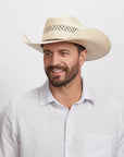 Smiling man with beard wearing a Roughstock Cowboy Hat and a white button-up shirt.