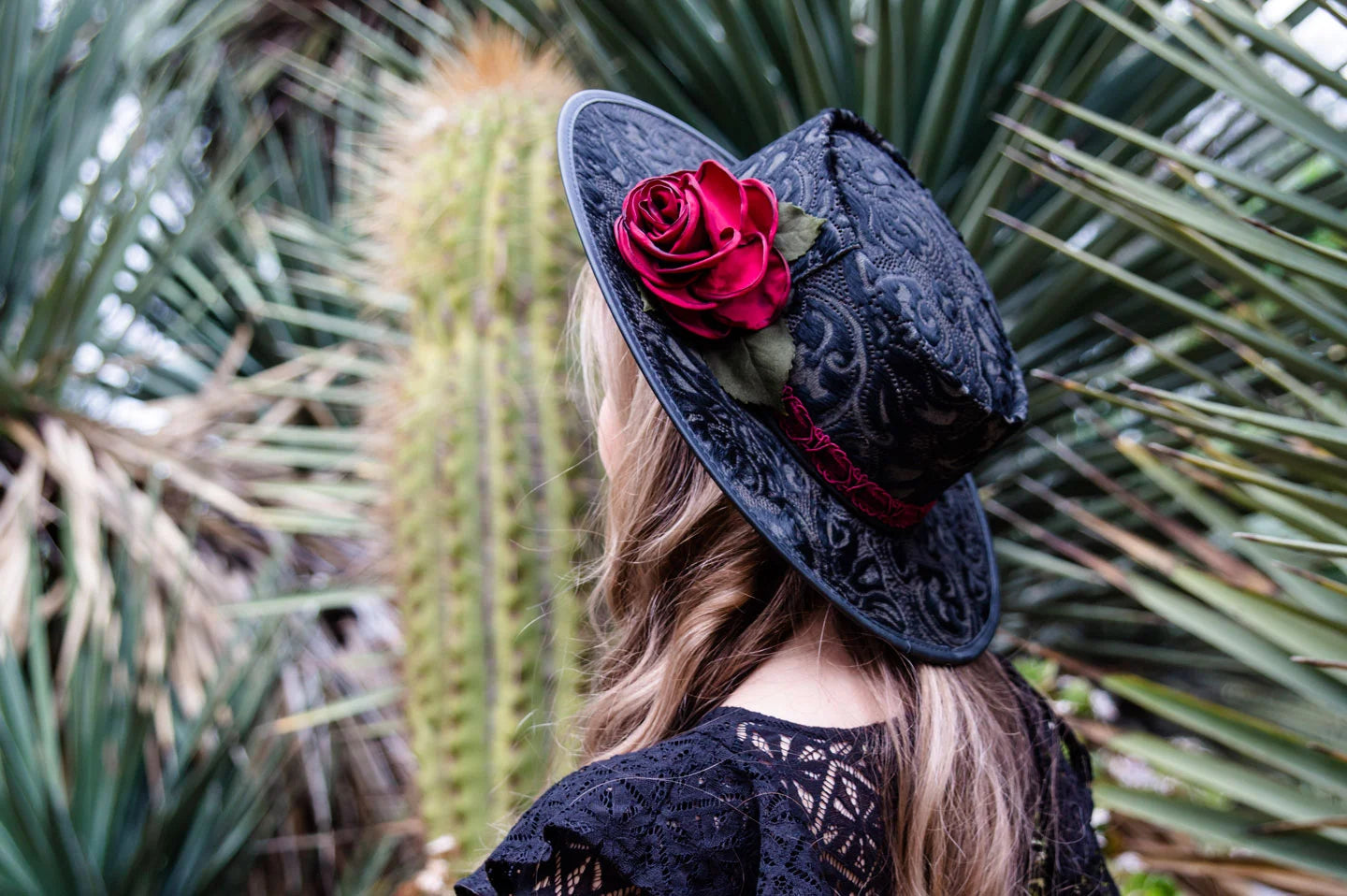 Woman in cactus garden wearing the Ruby womens couture hat by American Hat Makers
