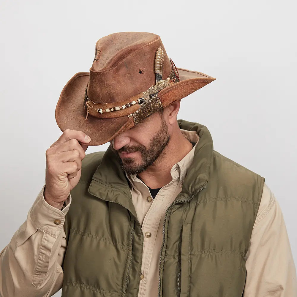 Man tipping a Sidewinder Leather Cowboy Hat, wearing a green button-up jacket over a black shirt