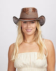 Smiling woman with blonde hair wearing a Sierra Brown Cowboy Hat, a light cream dress, and a gold necklace.