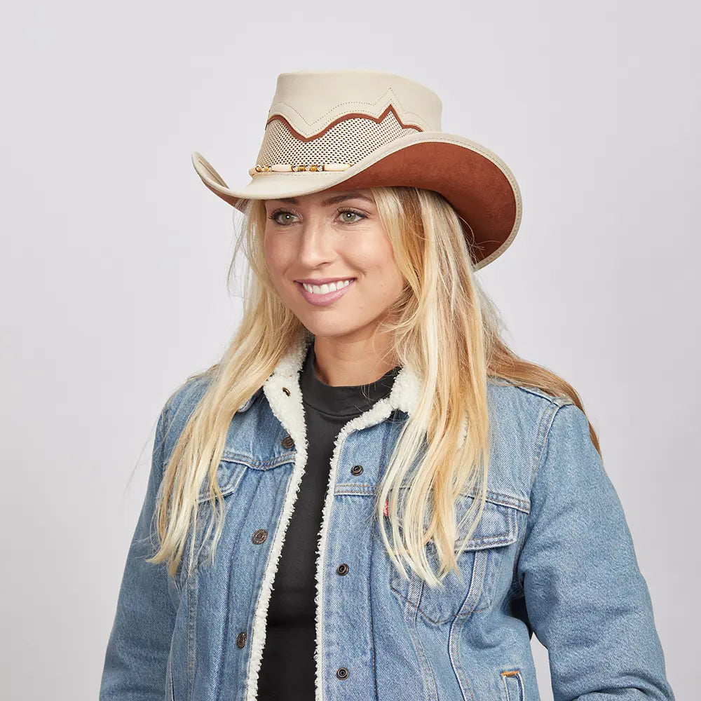 Smiling woman with blonde hair wearing a denim jacket and the Sierra Latte Cowboy Hat