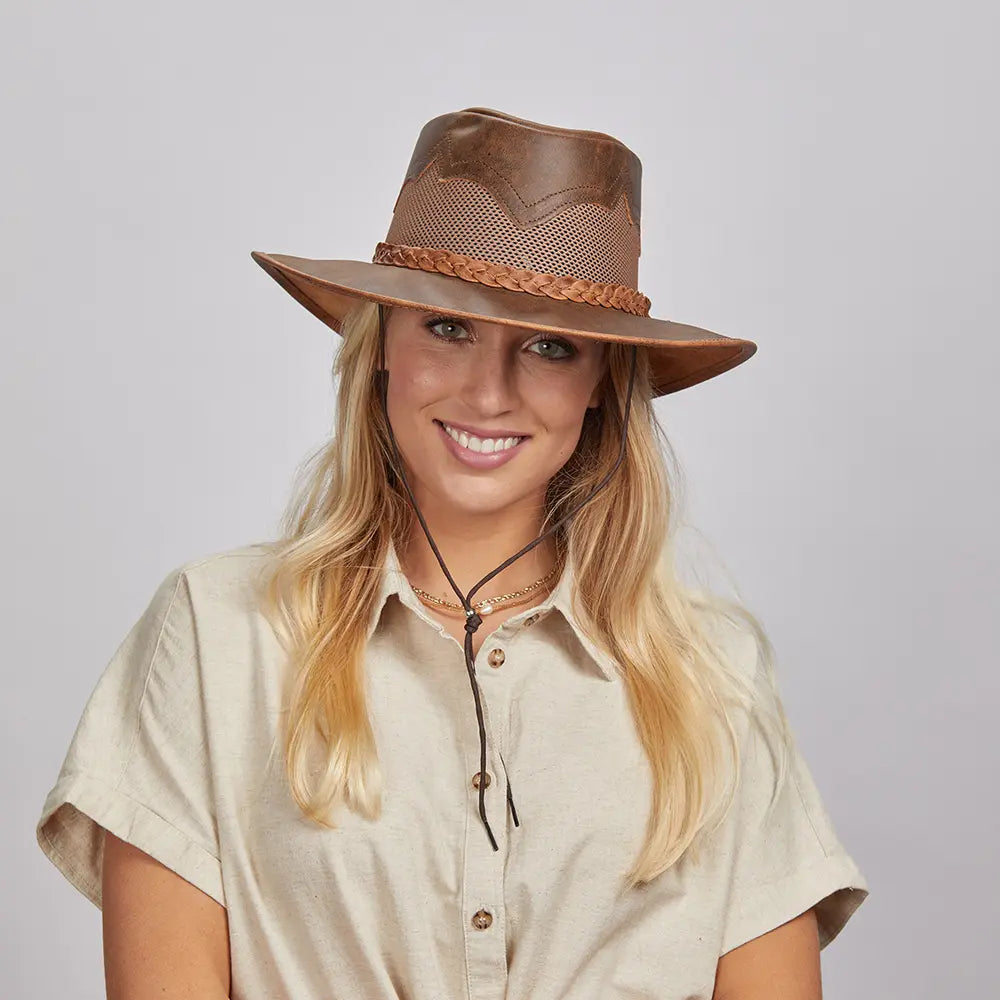 Smiling woman with blonde hair wearing a Sirocco Copper Outback Hat and a beige shirt