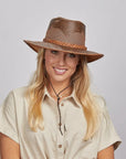 Smiling woman with blonde hair wearing a Sirocco Copper Outback Hat and a beige shirt