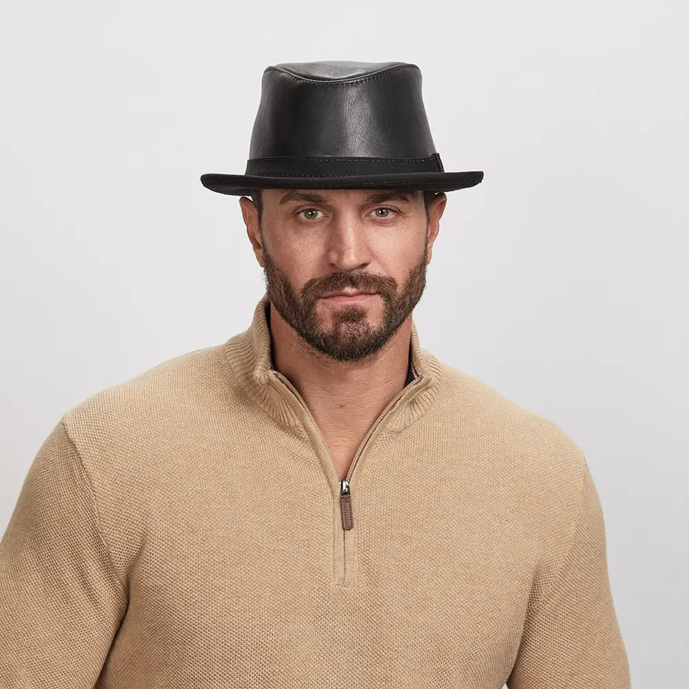 Man with a light stubble wearing a Soho Fedora Hat and beige zip-up sweater