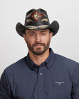 Man in dark blue button-up shirt wearing a Black Storm Cowboy Hat.
