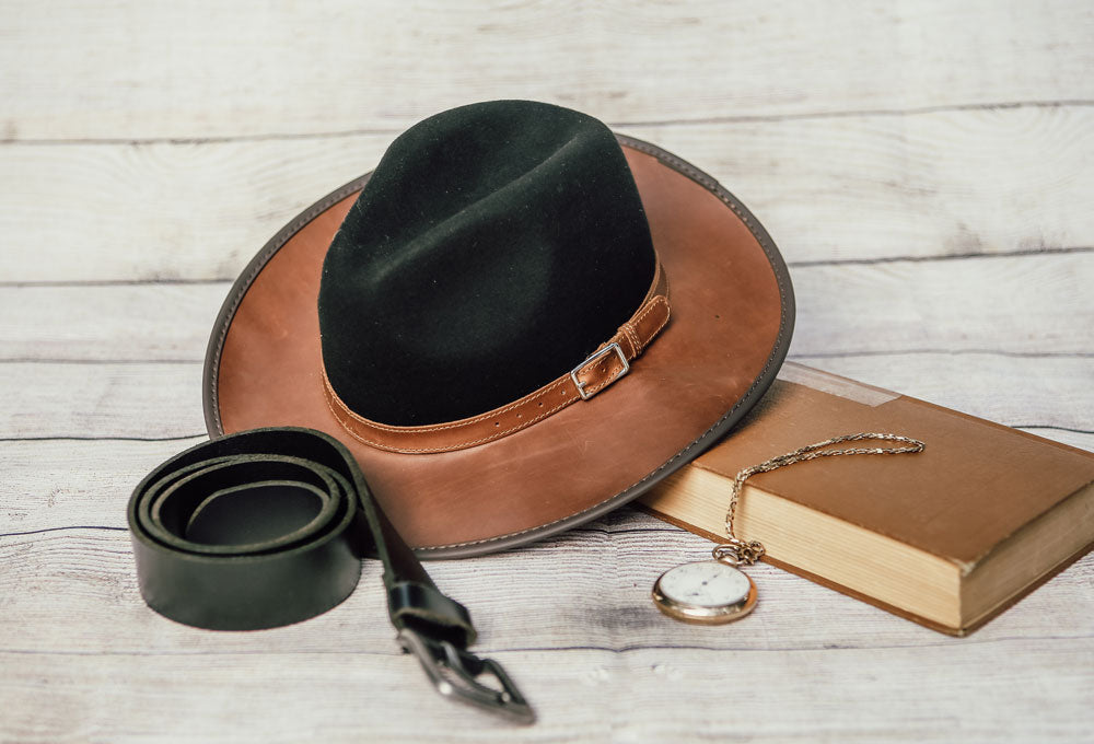 A black belt along with the coal colored summit hat on top of a book