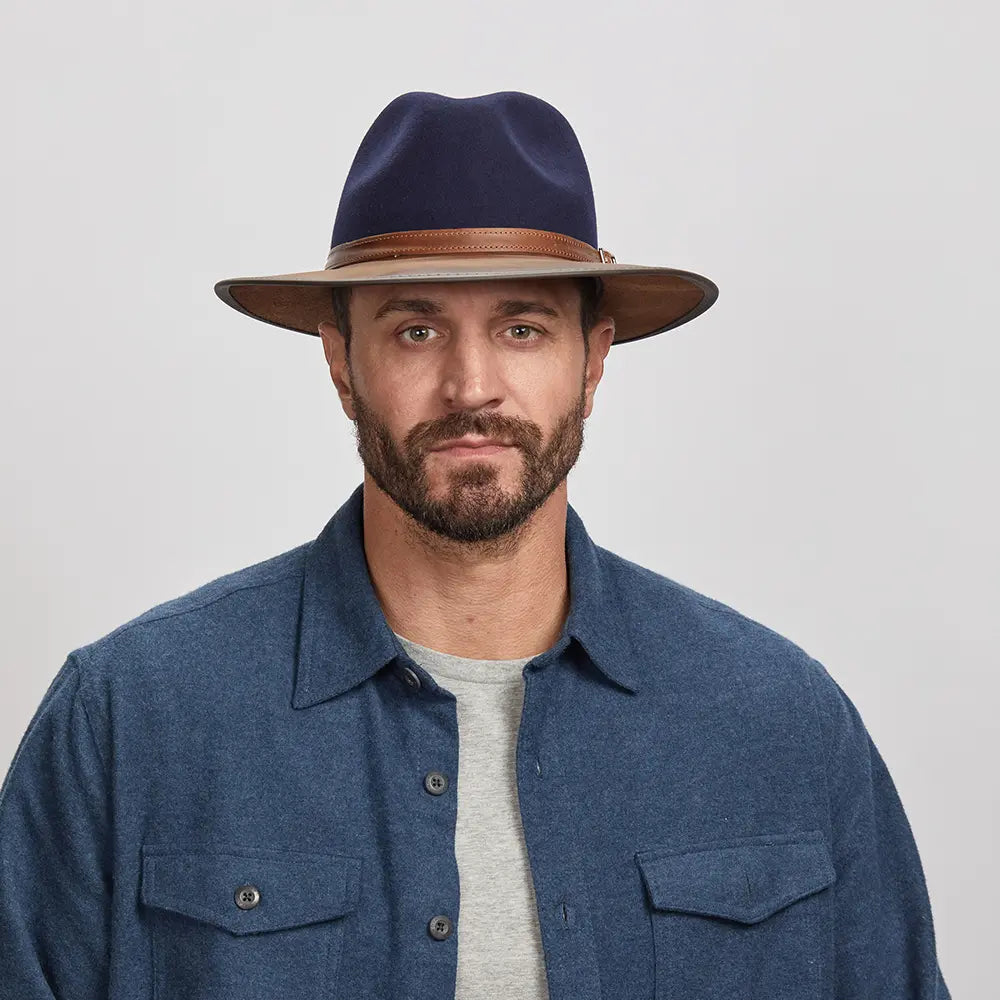 A man wearing the Summit Navy Felt Leather Fedora Hat