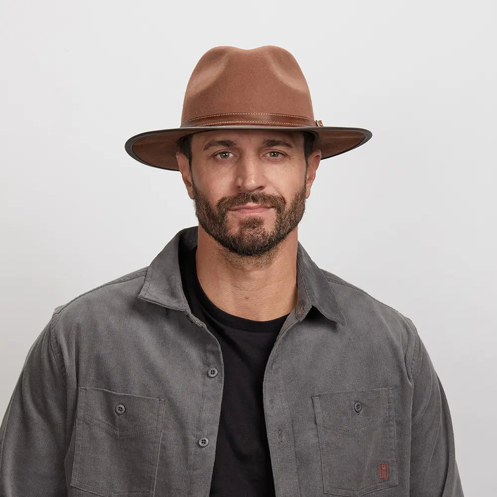 A man wearing the Summit Saddle Felt Leather Fedora Hat