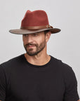 A man wearing the Summit Sangria Felt Leather Fedora Hat, looking slightly to the side.