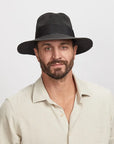 Man wearing a Black Afternoon Sun Hat and a light beige shirt