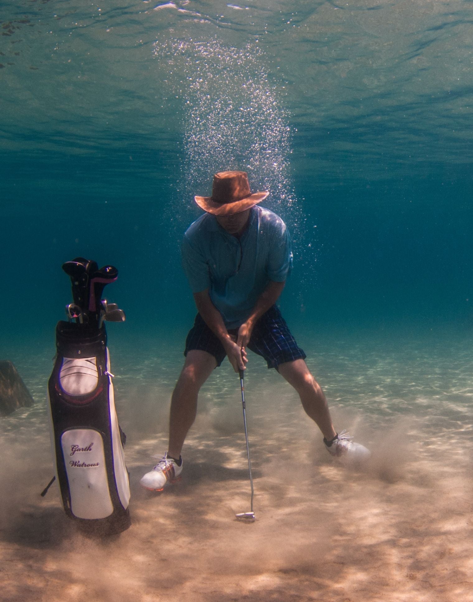 Garth playing golf under water while wearing the Soaker