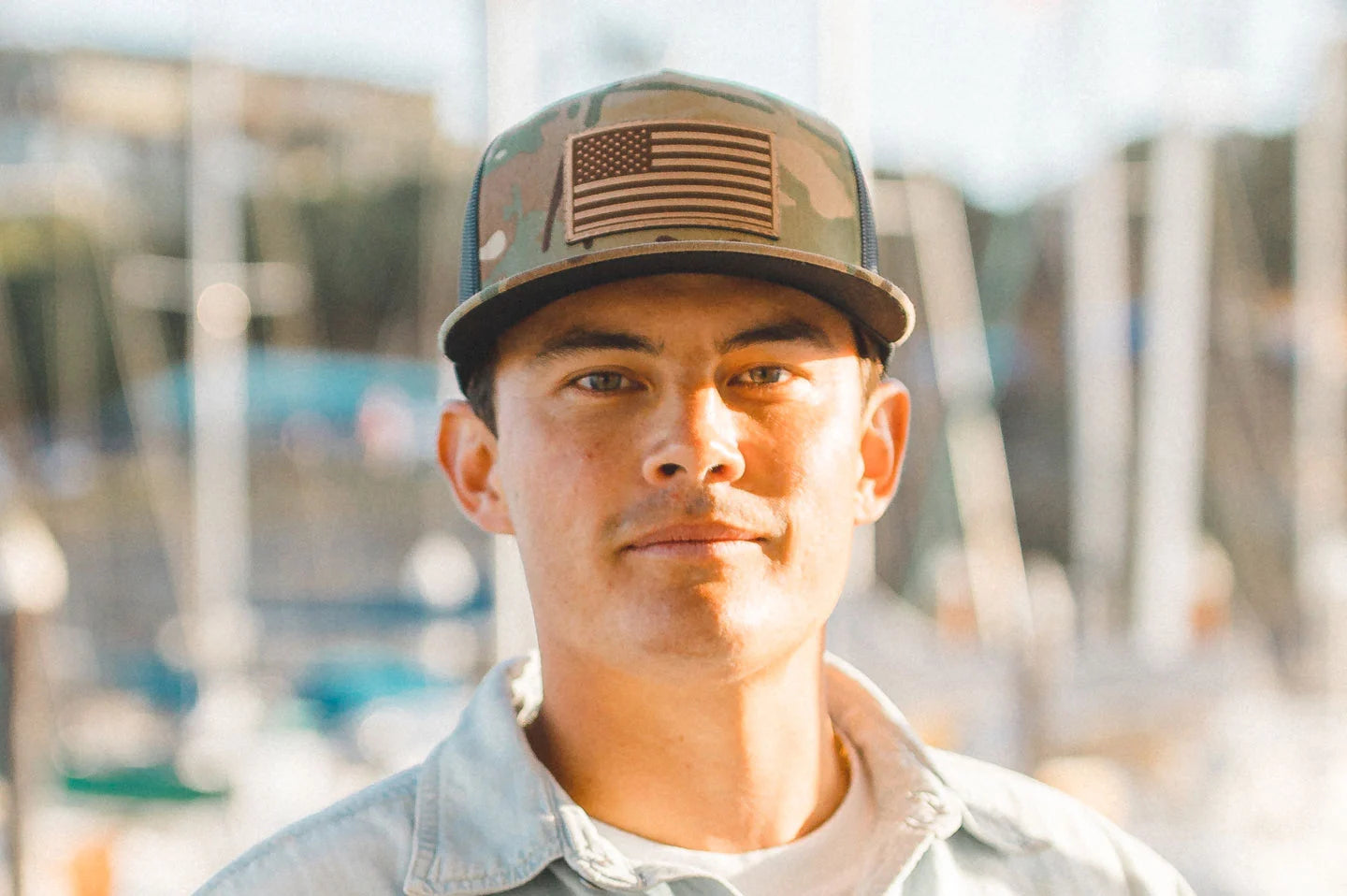 Man on boat wearing the camo trucker hat by American Hat Makers