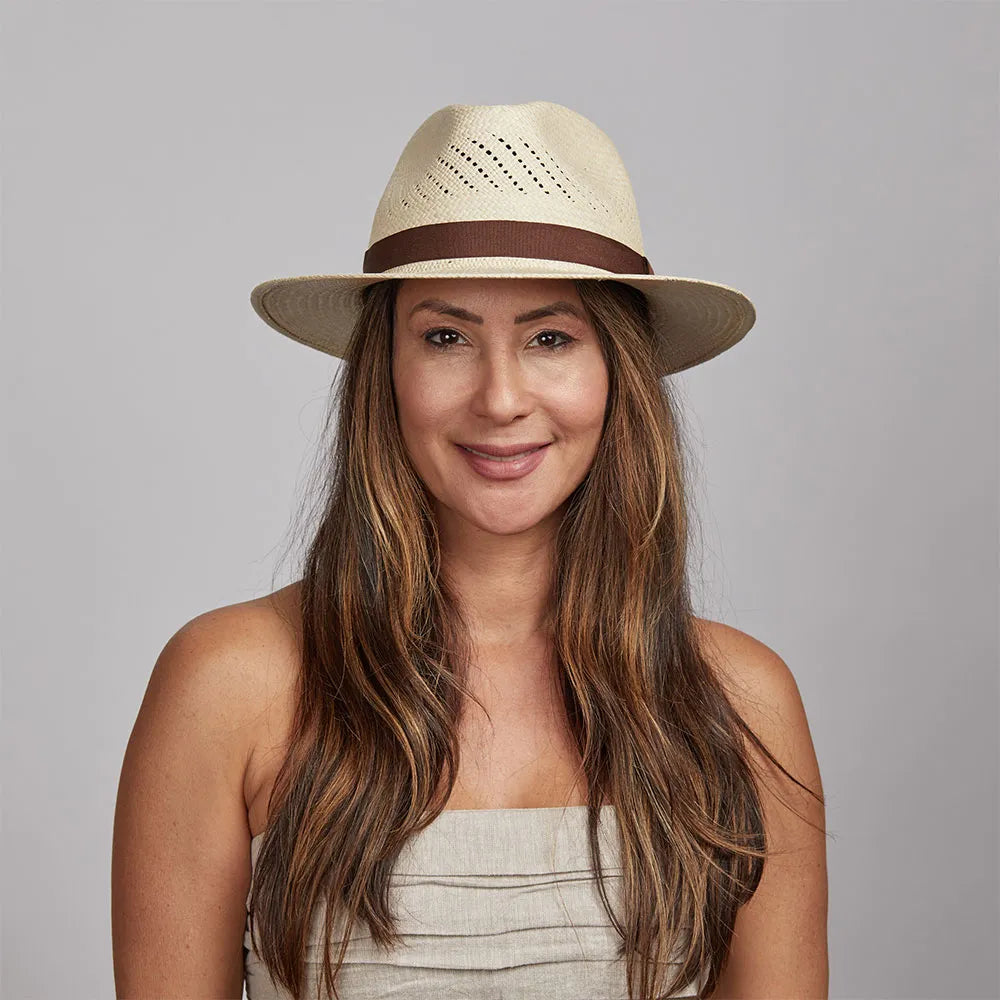 A woman  wearing a white tube and a panama sun hat