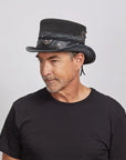 A man looking to the side wearing a black top and the Vector black top hat