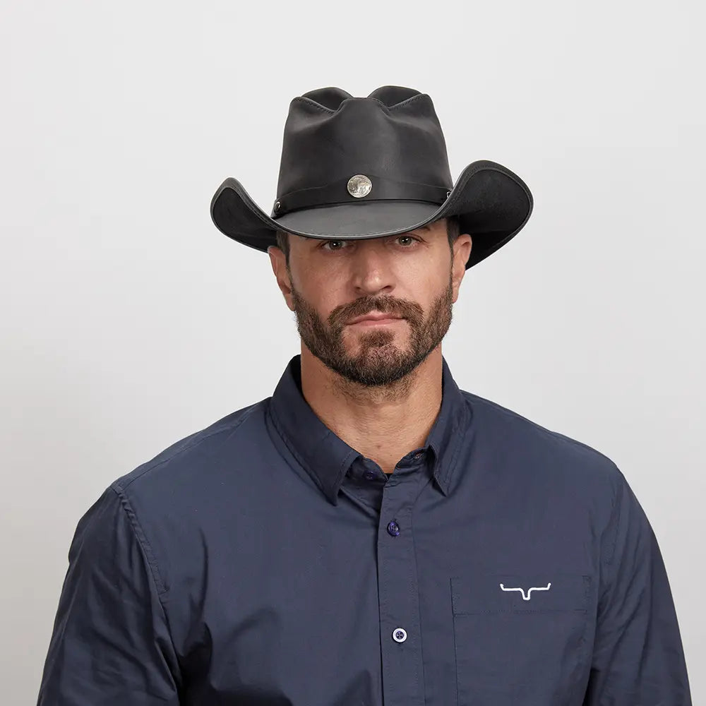 A man in a dark blue polo wearing the Western Black Leather Cowboy Hat