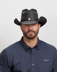 A man in a dark blue polo wearing the Western Black Leather Cowboy Hat