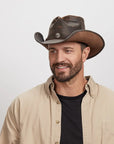 A man in a brown polo wearing the Western Chocolate Leather Cowboy Hat