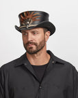 An young man in a black polo wearing the Wrath Black Top Hat looking to the side