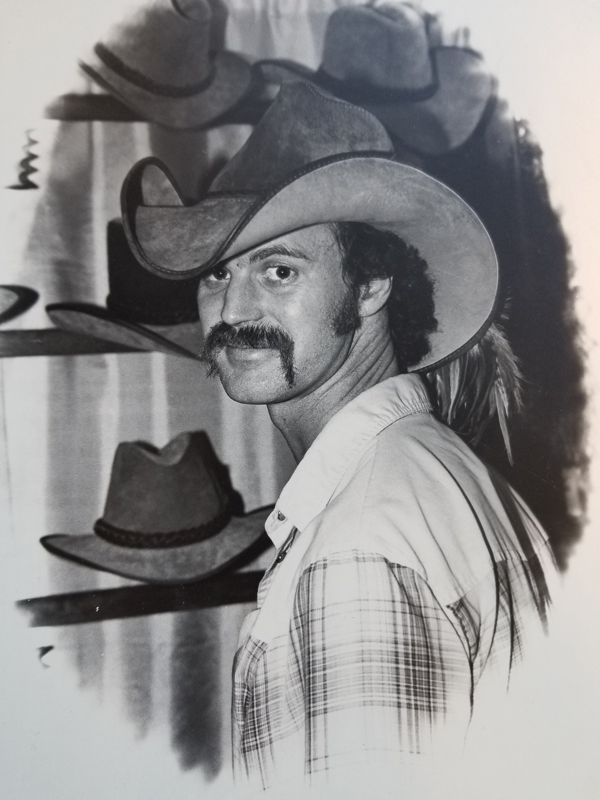 Gary on a hat booth wearing cowboy hat