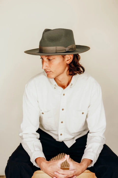 Man sitting while wearing the Geneva rhino felt mens fedora hat by American Hat Makers