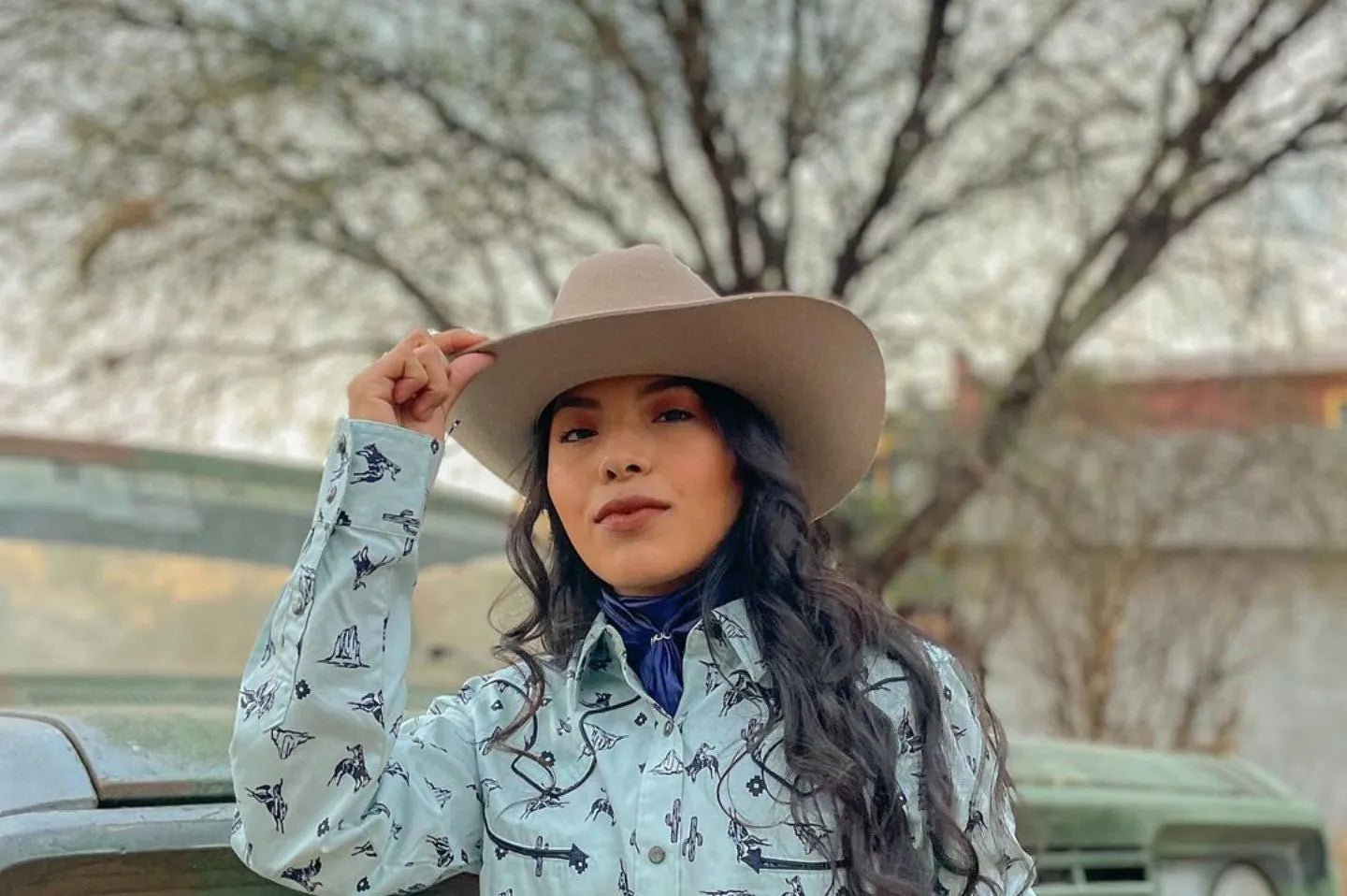 Woman next to truck wearing the cattleman cowboy hat by American Hat Makers