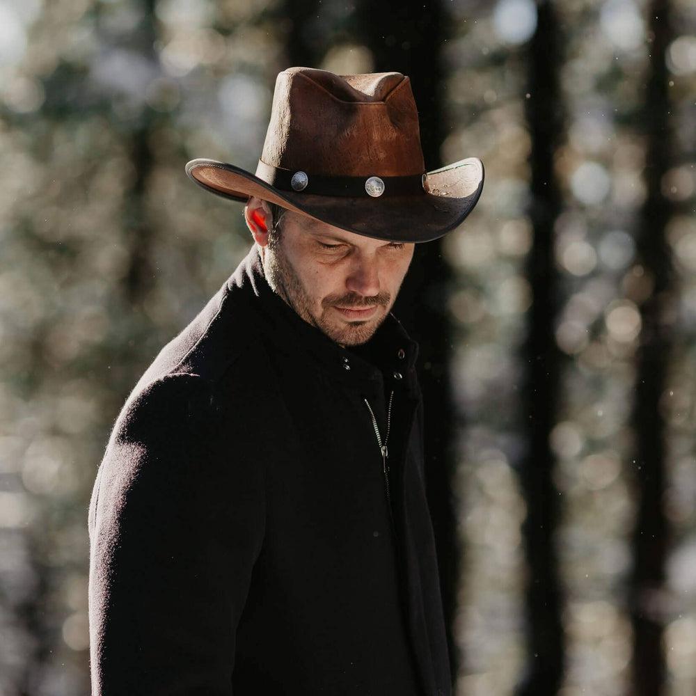 A man walking in the forest wearing Cobblestone Leather Cowboy Hat with 3&quot; Brim and 4&quot; Crown 