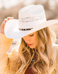 A woman wearing Billings Cream Straw Cowboy Hat on an angle side