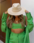 A man in a green outfit wearing Bisbee Straw Hat with Colorful Hat Band