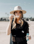 A woman playing bubble wearing Bondi Oatmeal Wide Brim Felt Fedora 