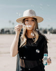 A woman playing bubble wearing Bondi Oatmeal Wide Brim Felt Fedora