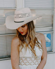 A woman wearing a Bozeman Cream Straw Cowboy Hat on an angle view