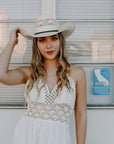 A woman in white dress wearing Bozeman Cream Straw Cowboy Hat 